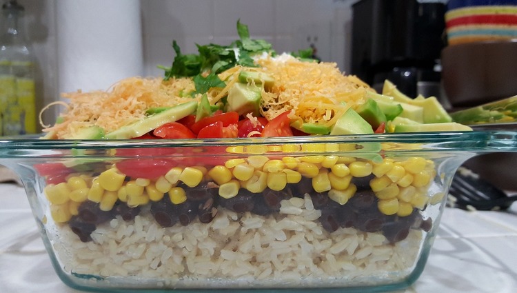Mexican Inspired Dinner with Beans, Avocado, Tomatoes, Corn, Rice and Shredded Cheese